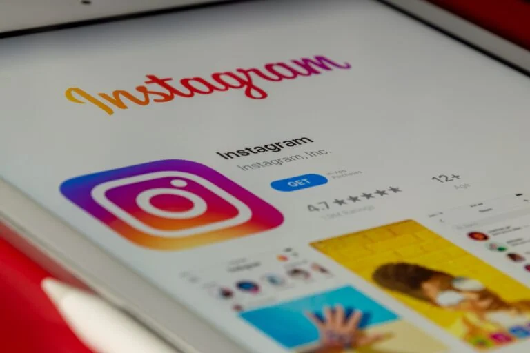vibrant collage featuring various elements of Instagram - app icon, a profile screen, an array of diverse user profile pictures, colourful posts with heart and comment symbols, and a magnified count of followers showing growth.