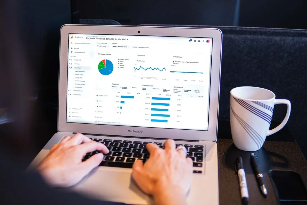 Illustration of a website appearing on top of a Google search results page with SEO icons and keywords surrounding it